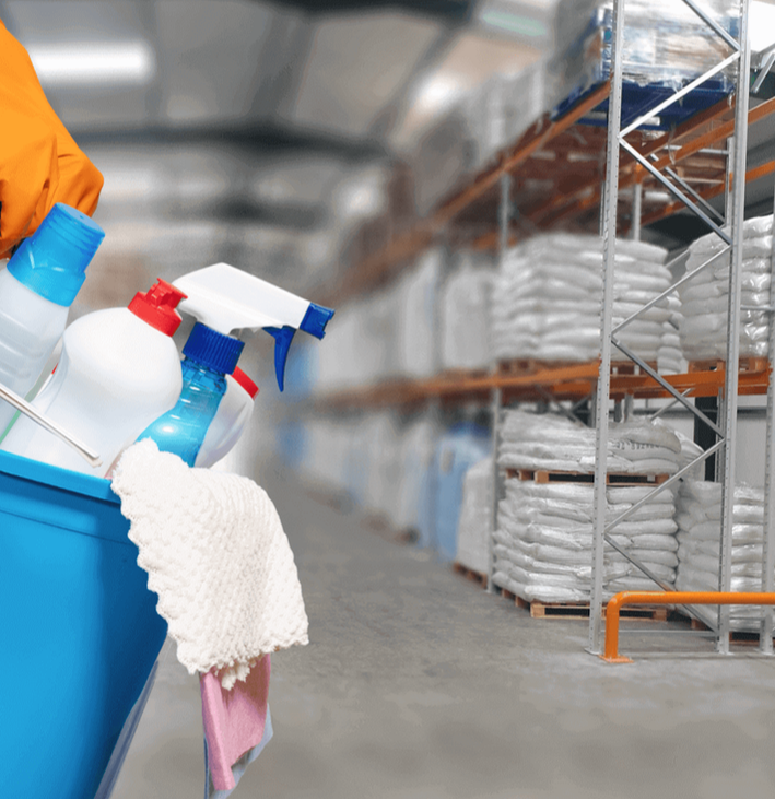 Warehouse in background cleaner with equipment in blue bucket