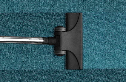 Vacuuming green carpet